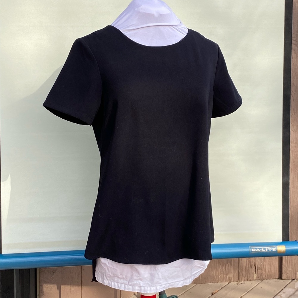 Freequent brand black blouse. High low hem. Substantial woven fabric. Size small